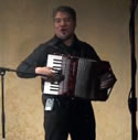 Joey deVilla playing accordion onstage at CUSEC 2009