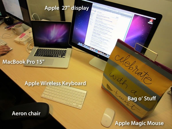 Shopify standard issue gear: Apple 27" display, MacBook Pro, Apple Wireless Keyboard, Aeron chair, Apple Magic Mouse, Bag O' Stuff