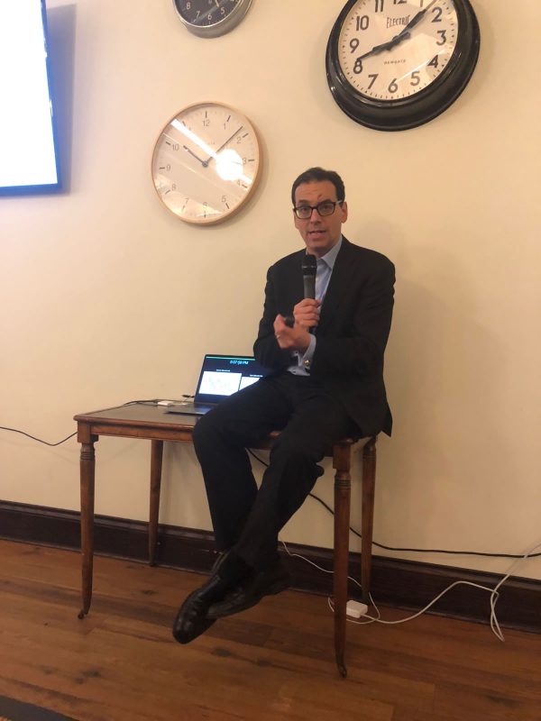 Daniel Pink with clocks in background.