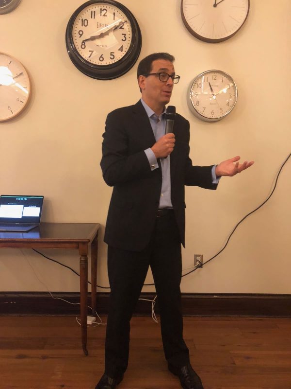 Daniel Pink with clocks in background