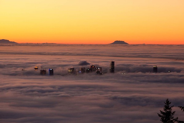 Photo of Vancouver skyline mostly obscured by fog