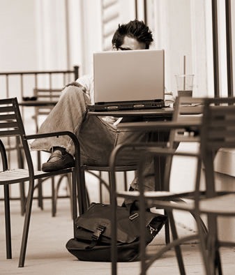 Guy in a cafe using a laptop