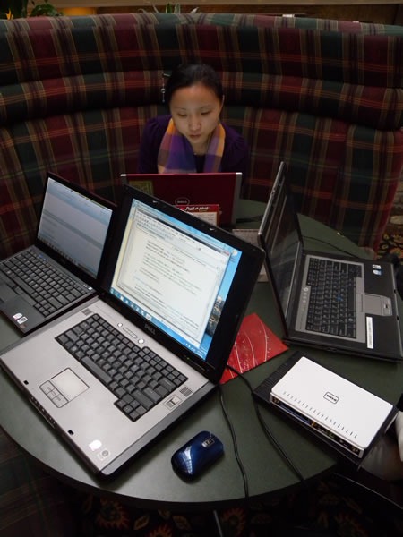 Qixing and computers in one of the round booths at the Cantata Lounge