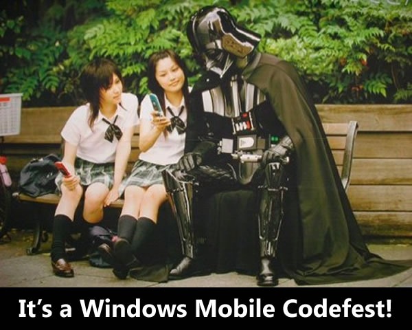 Two Japanese schoolgirls showing off their cellphones to Darth Vader