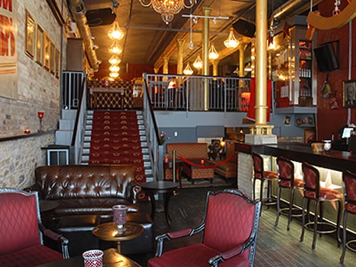 View of lower room and staircase at Pravda Vodka Bar