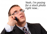 Man on mobile phone: "Yeah, I'm posing for a stock photo right now..."