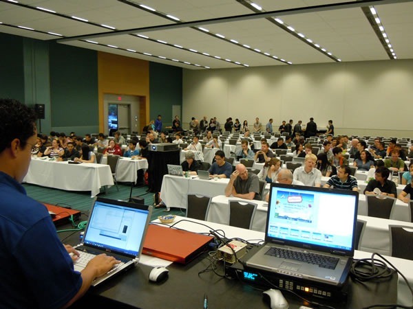 Photo of the session room, with Mark Arteaga setting up his computer in the foreground