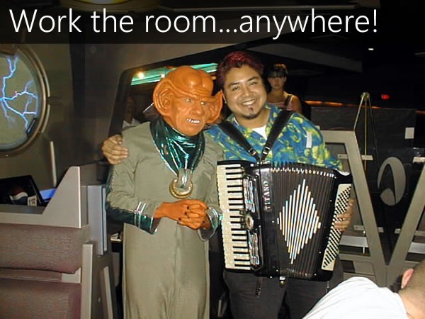 Joey deVilla, with accordion, schmoozing a Ferengi at Quark's