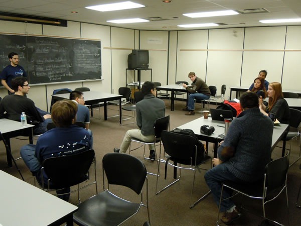 title Will Pate teaching the participants how to do a technical presentation
