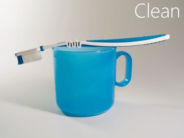 Toothbrush resting on a mug