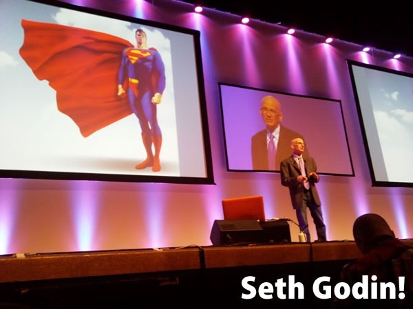 Seth Godin!: Seth Godin giving a presentation on stage in front of an image of Superman