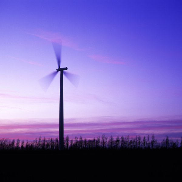 Modern windmill set against a purple sky