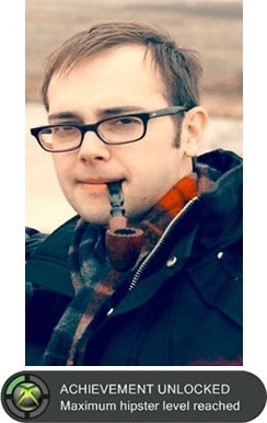 Photo of Edward Ocampo-Gooding in a Canada Goose parka, wearing a scarf, smoking a pipe and with an Xbox 360 achievement: "ACHIEVEMENT UNLOCKED: Maximum hipster level reached"