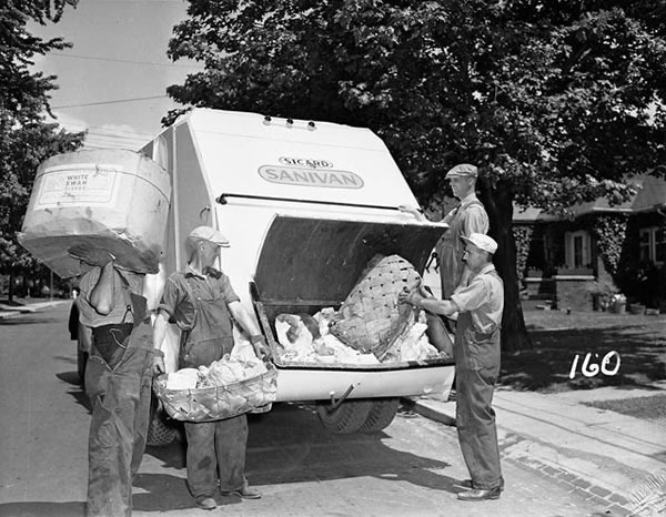 Old black and white photo of 1950s garbage collectors