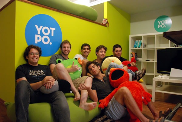 The Yotpo team, all gathered on a couch in their office