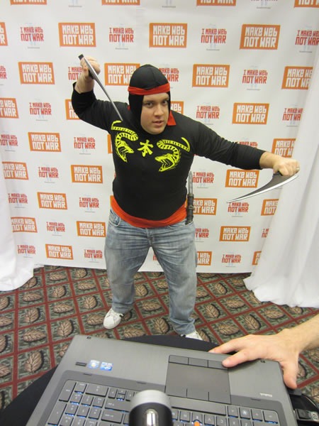 Fred Harper, Ninja Fred Harper in a ninja balaclava and wielding daggers, striking a ninja pose at the Make Web Not War ninja photo booth.