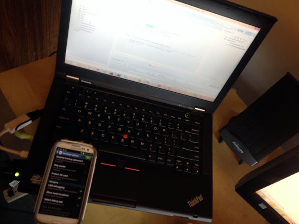 Android phone sitting on ThinkPad laptop