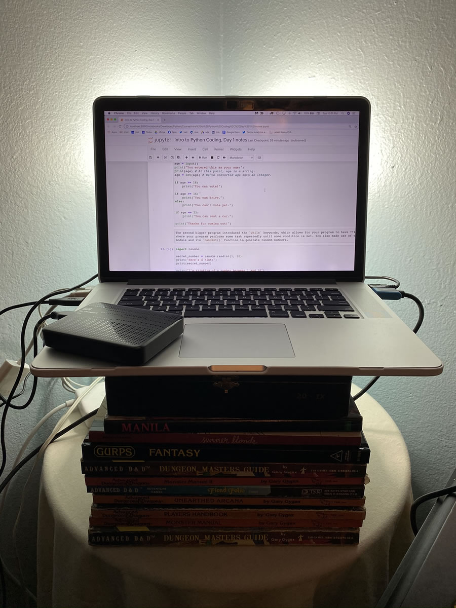 Photo: MacBook pro on the stack of books.