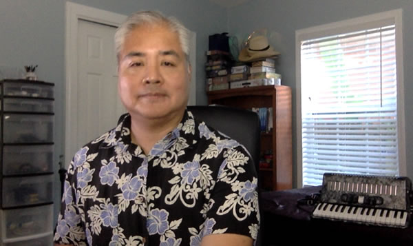 Photo: Joey deVilla in his home office, with his accordion in the background.