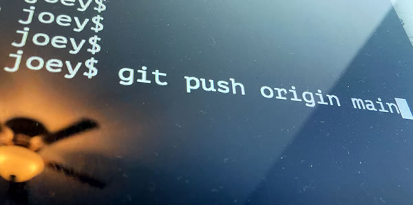 Photo: A computer screen showing “git push origin main”.
