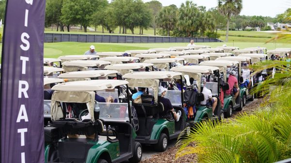 Golf carts lined up and filled with players ready to play in the Tampa Bay Tech Golf Classic