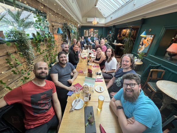 Photo of a long table with many of the  Auth0 Developer Engagement team having dinner at Mulberry Bush, London.