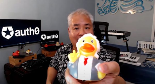 Joey deVilla in his home office, holding an “Einstein” rubber duck up to the camera.