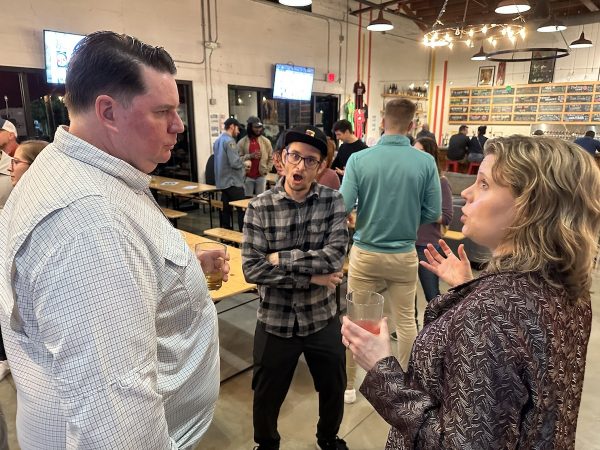 A close-up of a conversation at the Tampa Bay UX Group Revival Social, with Micah Overton hamming it up for the camera.