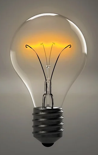 A lit “Edison”-style lightbulb.
