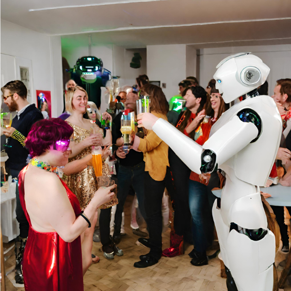 Another very “uncanny valley” Canva AI-generated photorealistic image of robots and humans having a great time at a party.